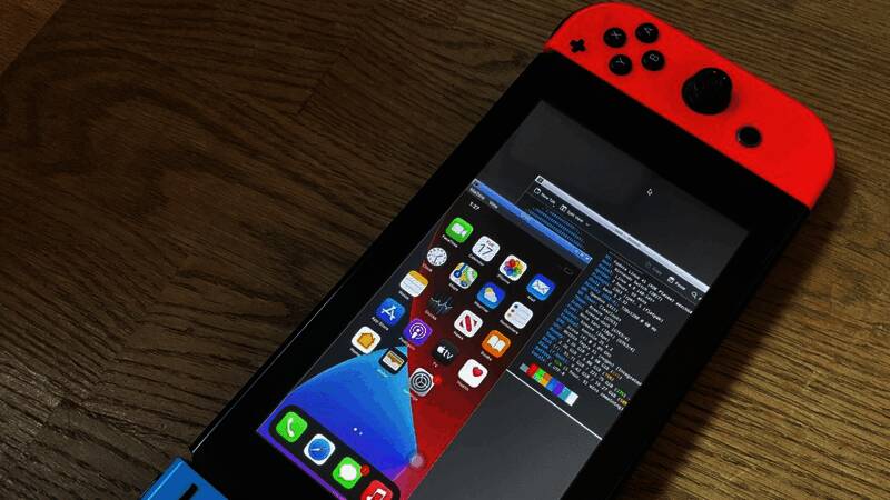 极客展示在Switch上运行iOS系统的实验画面，屏幕显示iOS启动界面