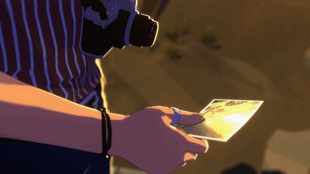 一张已拍摄完成的照片预览，背景是夕阳下的山脉