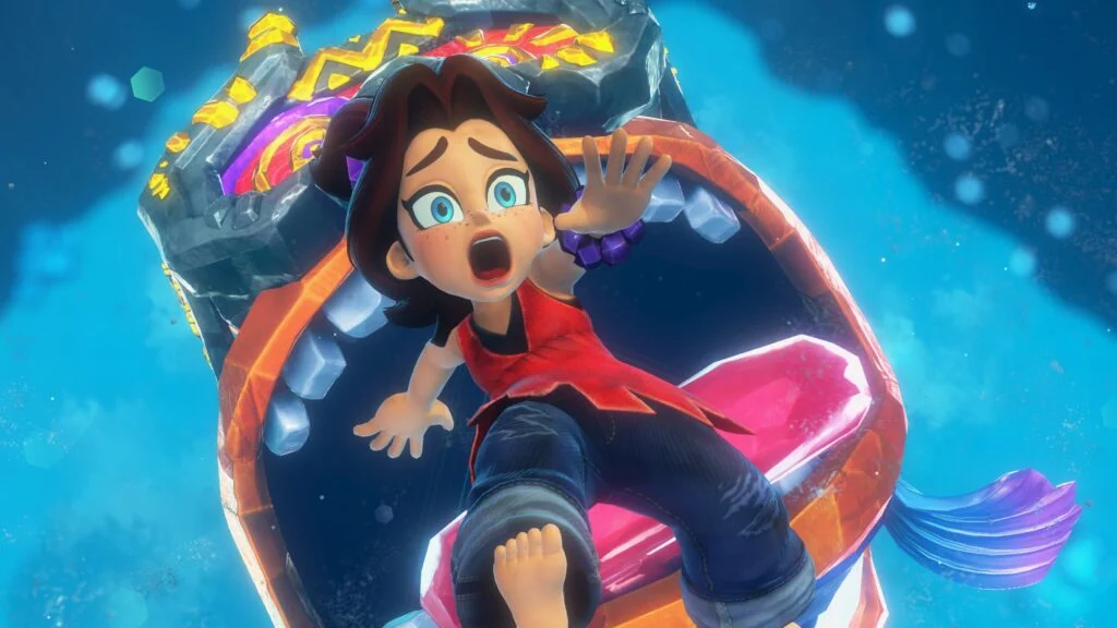 玩家手持《咚奇刚:蕉力全开》实体卡带与Switch 2主机合影,背景可见游戏包装盒